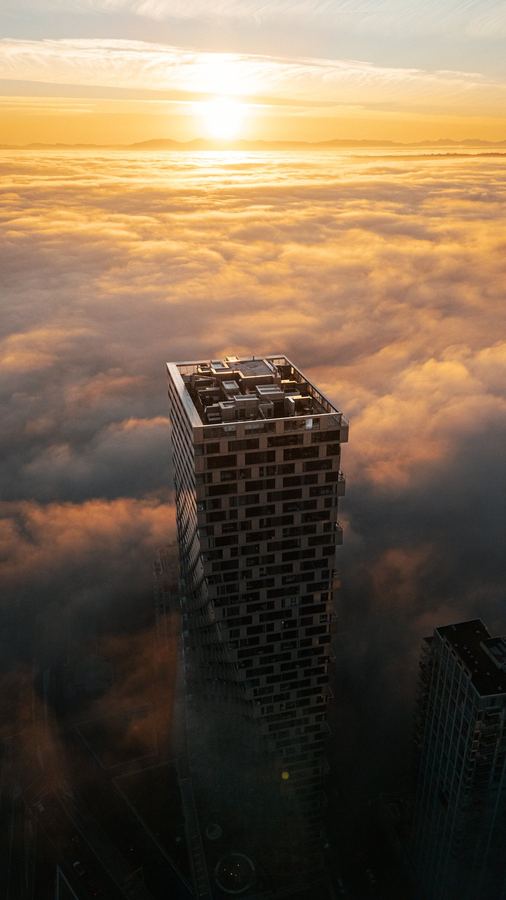 Tower above the clouds at sunset