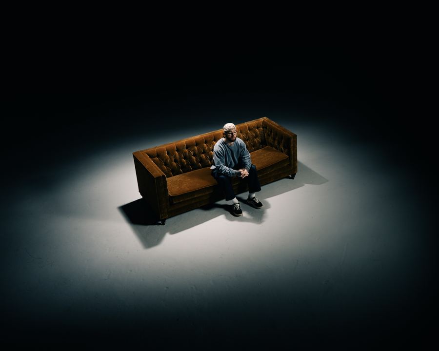Alone on the couch, spotlit