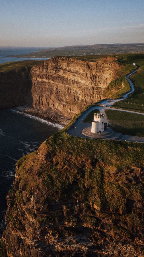 Coastal cliffs and lighthouse road, aerial